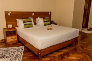 Voodi või voodid majutusasutuse The Glacier Hotel Nanyuki toas