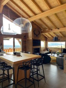 a kitchen and living room with a wooden table and chairs at Chalet Standing Exceptionnel in Bolquere Pyrenees 2000