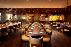 a dining room with a long table and chairs at Hilton Suzhou in Suzhou