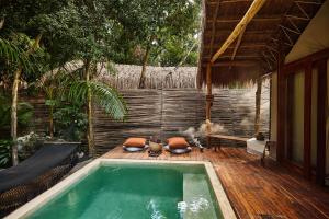 a swimming pool in the middle of a house at Our Habitas Tulum in Tulum