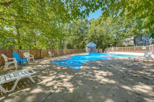 a swimming pool with a bench and a gazebo at 3 Mi to Silver Dollar City! Family Getaway w/ Pool in Branson