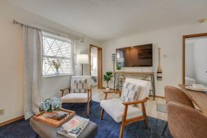 a living room with two chairs and a table at 3 Mi to Silver Dollar City! Family Getaway w/ Pool in Branson