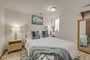 a bedroom with a white bed with pillows and a mirror at 3 Mi to Silver Dollar City! Family Getaway w/ Pool in Branson +22 photos
