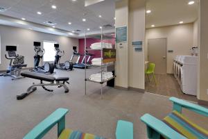 a room with a gym with exercise equipment and chairs at Home2 Suites By Hilton Duncan in Duncan