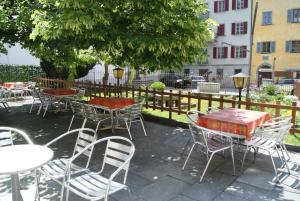 a group of tables and chairs in front of a fence at Albergo Piz Cam in Vicosoprano