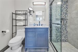 a blue bathroom with a toilet and a shower at Tower 9 #6 in Oceanside +71 photos