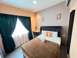 a bedroom with a bed with a large window at The Tree Boutique Hotel in Shah Alam