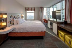 a hotel room with a bed and a large window at Hampton Inn & Suites Atlanta-Midtown, Ga in Atlanta