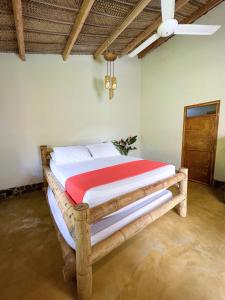 a bedroom with a wooden bed in a room at Tayrona Cachaco River Ecohostal in El Zaino