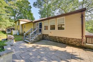 a yellow house with a patio in front of it at Waltham Vacation Rental about 12 Mi to Downtown Boston in Waltham