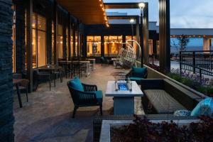 a restaurant with a patio with tables and chairs at Hilton Garden Inn Seattle Lynnwood, Wa in Lynnwood