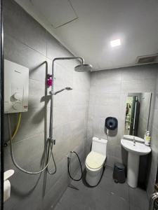 a bathroom with a shower and a toilet and a sink at The Tree Boutique Hotel in Shah Alam