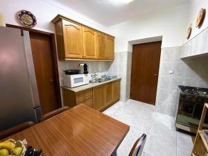 a small kitchen with a table and a microwave at Casa da Avó Pipa in Reguengos de Monsaraz +31 photos