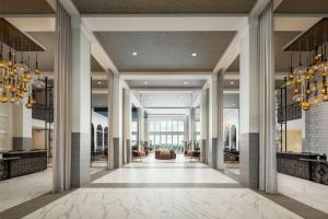 a lobby of a hotel with columns and chandeliers at The Cassara Carlsbad, Tapestry Collection By Hilton in Carlsbad