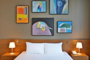 Giường trong phòng chung tại Aleph Doha Residences, Curio Collection By Hilton