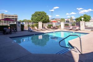 a large swimming pool with chairs at Hampton Inn Albuquerque - University/Midtown in Albuquerque