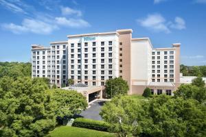 an aerial view of a hotel with trees at Hilton Charlotte Airport Hotel in Charlotte