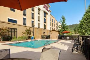 a hotel with a swimming pool in front of a building at Hampton Inn & Suites Birmingham/280 East-Eagle Point in Hoover