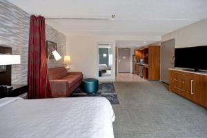 a hotel room with a bed and a flat screen tv at Home2 Suites by Hilton Nashville Vanderbilt, TN in Nashville +40 photos