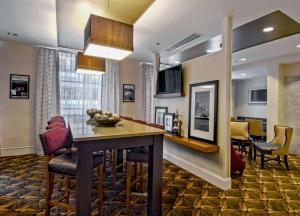 a living room and dining room with a table and chairs at Hampton Inn Majestic Chicago Theatre District in Chicago