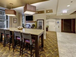 an open kitchen and dining room with a table and chairs at Hampton Inn Majestic Chicago Theatre District in Chicago