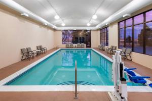 a pool in a building with a indoor swimming pool at Hampton Inn Denver-International Airport in Denver