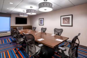 a conference room with a wooden table and chairs at Hampton Inn Denver-International Airport in Denver