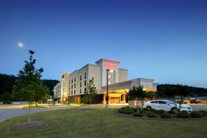 a building with a car parked in front of it at Hampton Inn Birmingham/Leeds in Leeds