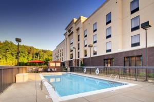 a swimming pool in front of a building at Hampton Inn Birmingham/Leeds in Leeds