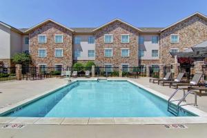 a swimming pool in front of a building at Homewood Suites by Hilton Oklahoma City-West in Oklahoma City
