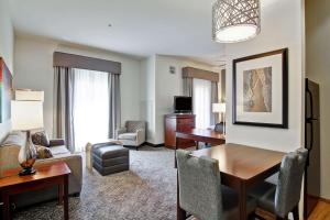 a living room with a desk and a dining room at Homewood Suites by Hilton Oklahoma City-West in Oklahoma City