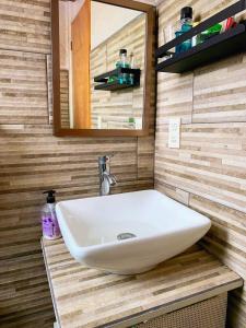 a bathroom with a white sink and a mirror at Depto Nuevo cerca del foro sol "Andy" in Mexico City