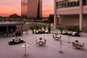 a rooftop patio with tables and chairs on a building at Hilton Atlanta in Atlanta