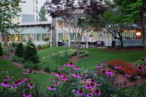 a garden in front of a building with flowers at Embassy Suites by Hilton Boston Marlborough in Marlborough