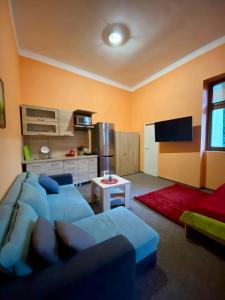 a living room with a couch and a tv at Thermal Apartments in Teplice