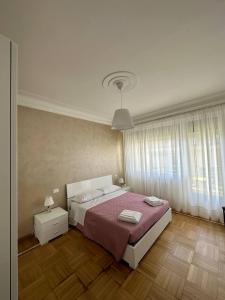 a bedroom with a large bed with a red blanket at La Casa di Gi&Vi in Sanremo +28 photos
