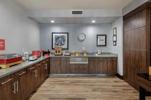 a large kitchen with wooden cabinets and a counter top at Hampton Inn Brownwood in Brownwood
