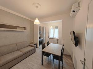 a living room with a couch and a table with chairs at La Casa di Gi&Vi in Sanremo