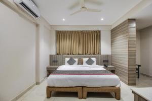 a bedroom with a large bed and a window at Collection O Avasa Grand in Old Goa