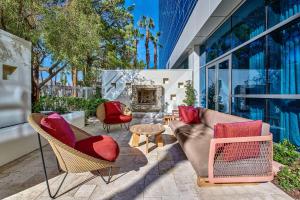 a patio with chairs and a couch and a fireplace at Virgin Hotels Las Vegas, Curio Collection by Hilton in Las Vegas