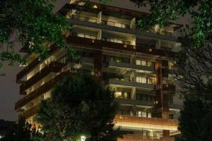 a tall apartment building with its lights on at Salvio Parque 93 Bogota, Curio Collection by Hilton in Bogotá