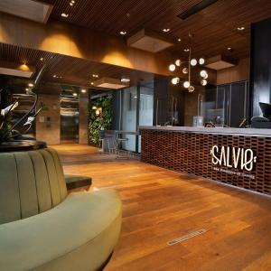 a lobby with a salon with a chair and a counter at Salvio Parque 93 Bogota, Curio Collection by Hilton in Bogotá