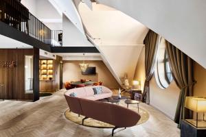 a living room with a couch and a table at Telegraphenamt in Berlin +130 photos