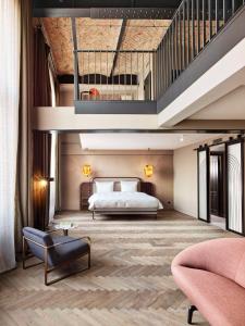 a hotel room with a bed and a staircase at Telegraphenamt in Berlin