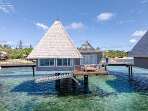 a house on a pier in the water at DoubleTree by Hilton Noumea Ilot Maitre Resort in Ilot Maitre