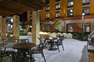 a patio with tables and chairs in front of a building at Home2 Suites By Hilton Orlando Flamingo Crossings, FL in Orlando +38 photos