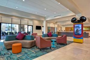 a lobby with couches and chairs in a hotel at Home2 Suites By Hilton Orlando Flamingo Crossings, FL in Orlando