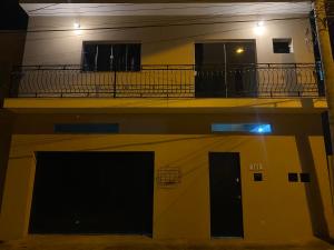 a building with a balcony on the side of it at Apartamentos C7 in Cunha