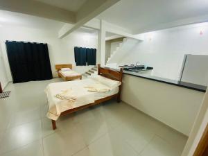 a hospital room with a bed and a sink at Apartamentos C7 in Cunha