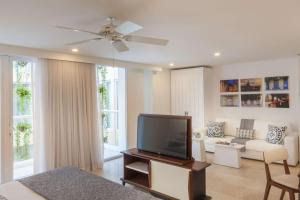 a living room with a television and a couch at Nacar Hotel Cartagena, Curio Collection by Hilton in Cartagena de Indias